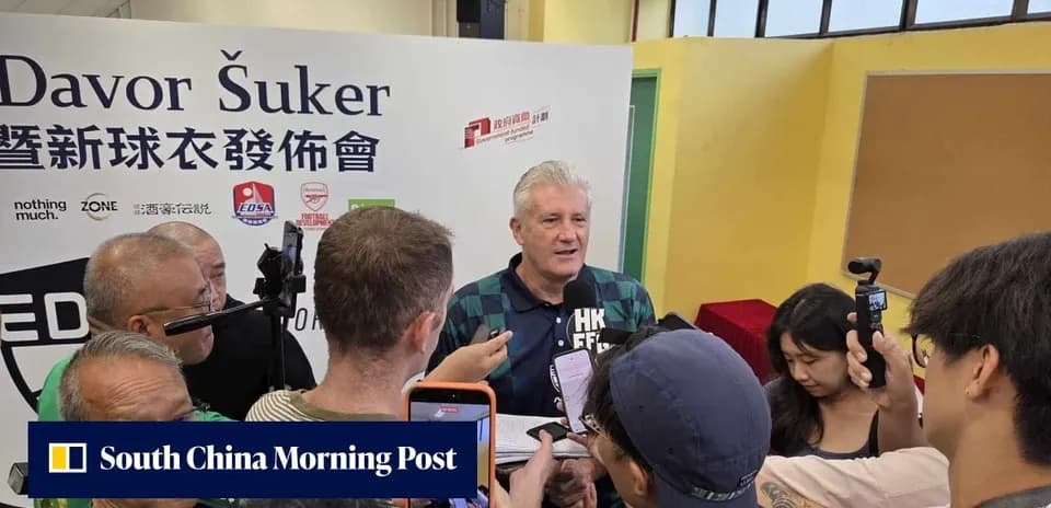 Davor Šuker speaking at press event surrounded by media