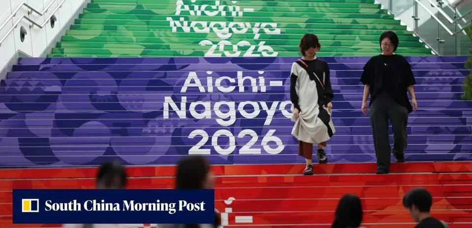 Two women walking down colorful Aichi-Nagoya 2026 steps