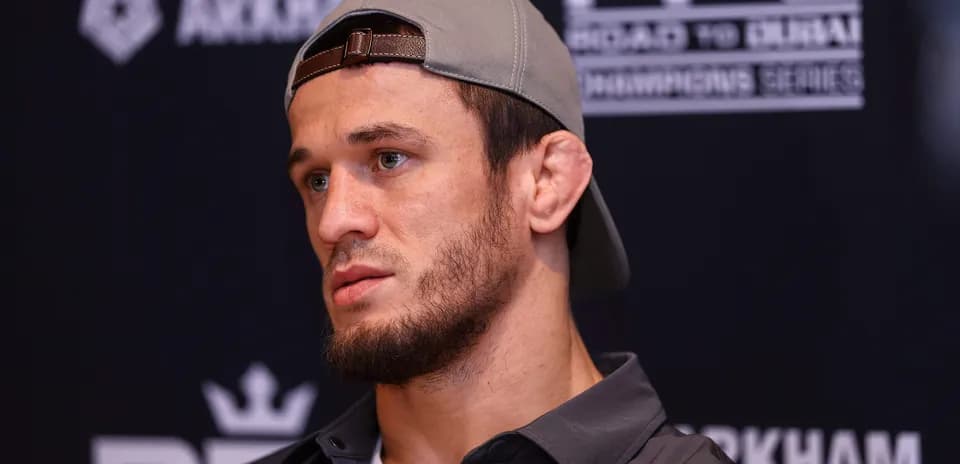 Athlete at press conference wearing a cap
