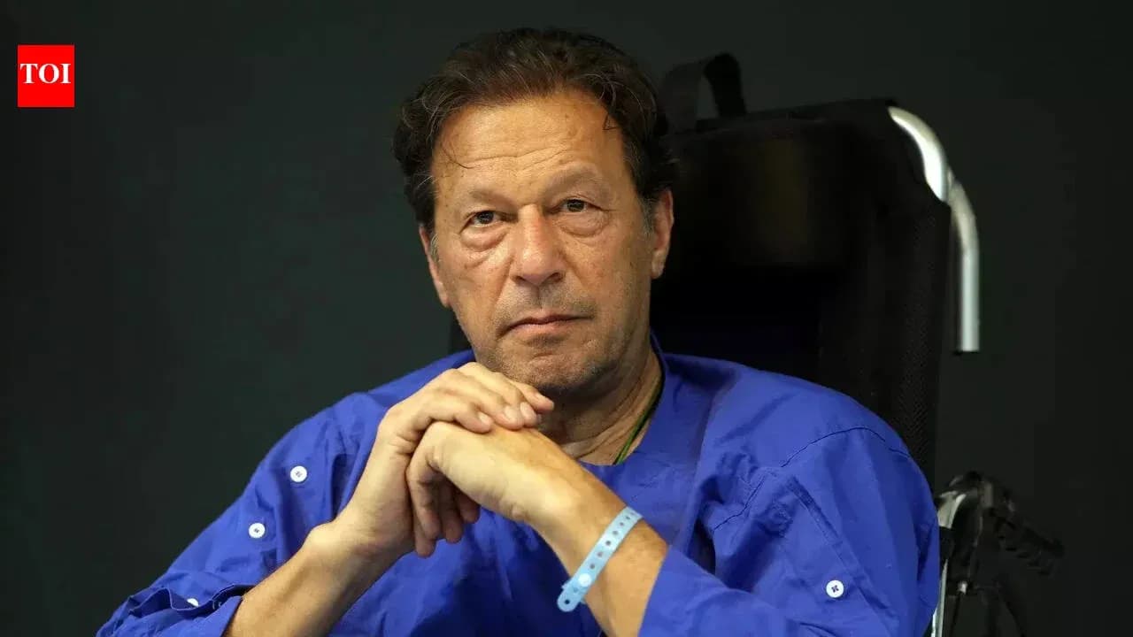 Man in wheelchair wearing blue shirt, serious expression