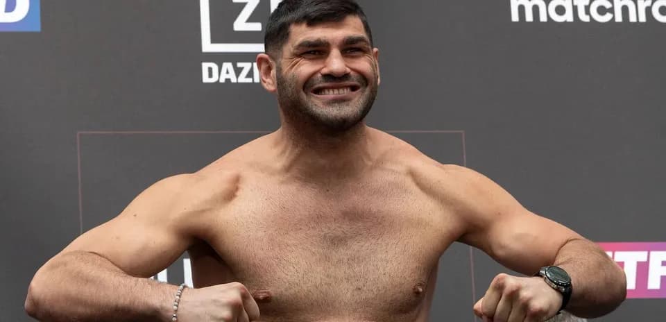 Fighter posing on scale at weigh-in event