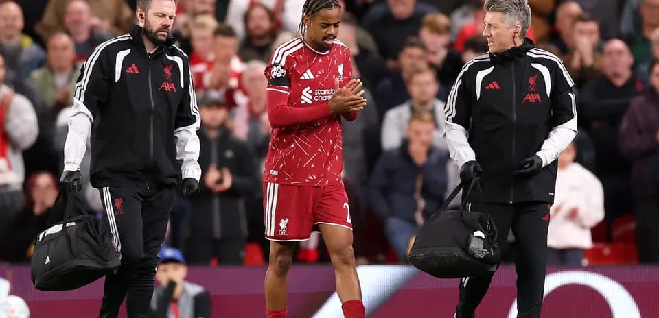 Liverpool player leaving field with medical staff