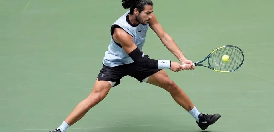 Tennis player hitting a backhand shot on court