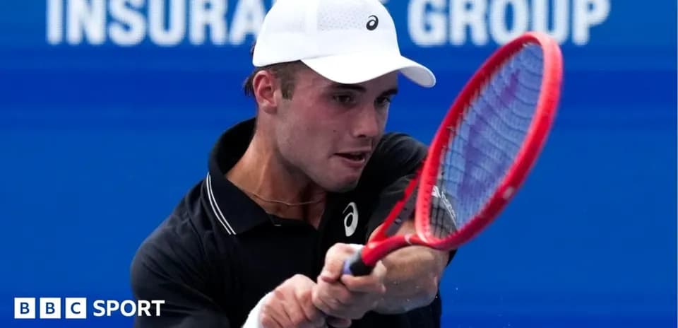 Tennis player striking the ball with a racket