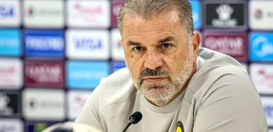 Coach at press conference with microphone in front