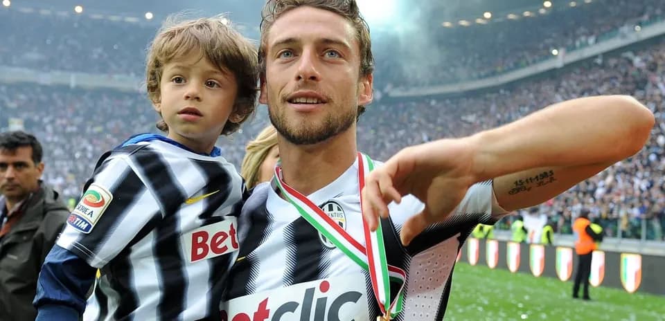 Player holding child, celebrating victory in stadium
