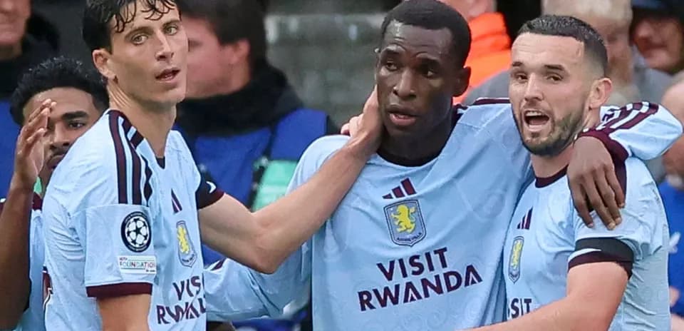 Three Aston Villa players celebrating a goal together