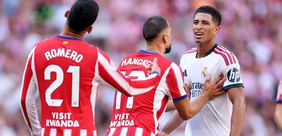 Atletico players confronting Real Madrid player on field