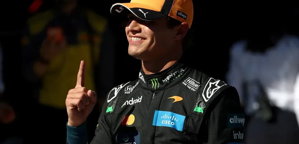 Driver celebrating with finger raised in pit area