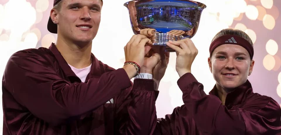 Players celebrating with trophy after winning championship