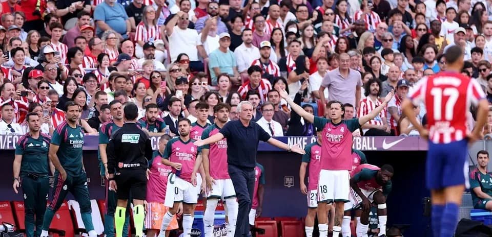 Coaching staff and players on the sideline during match