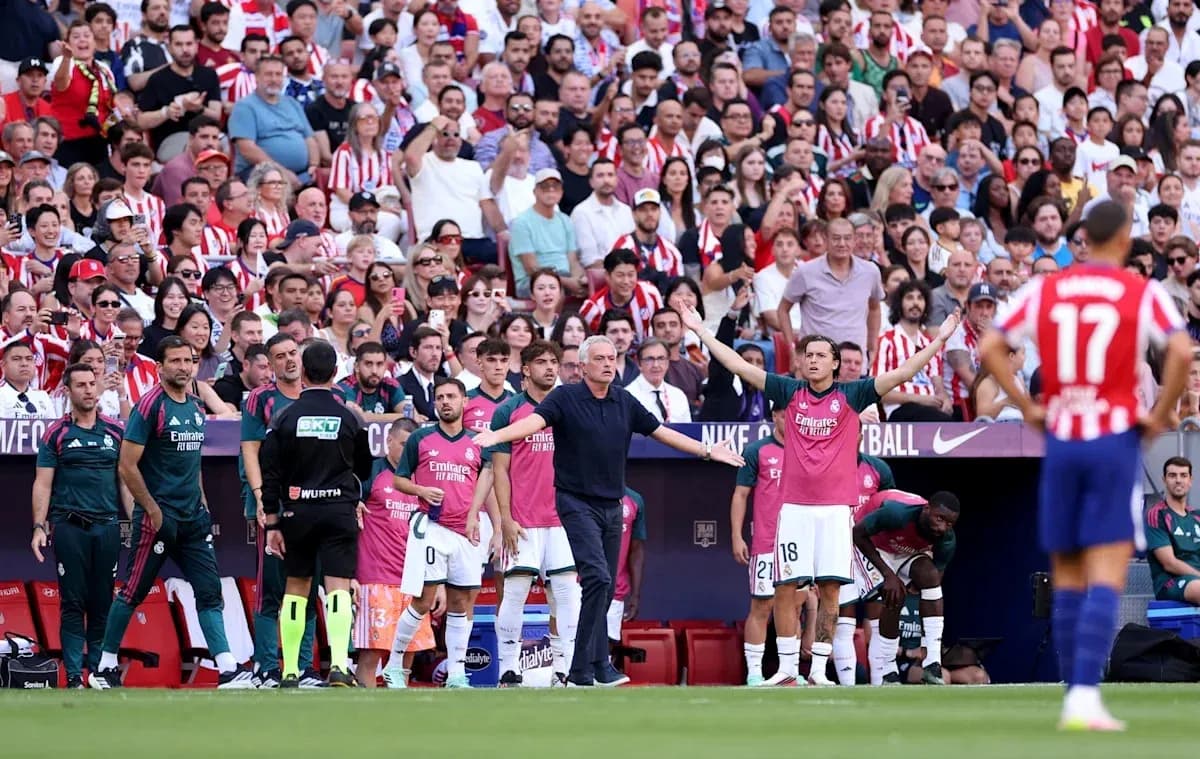 Coaching staff and players on the sideline during match
