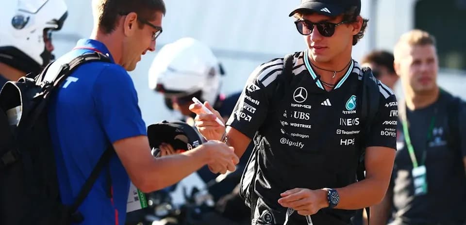 Driver signing autographs for fans at event