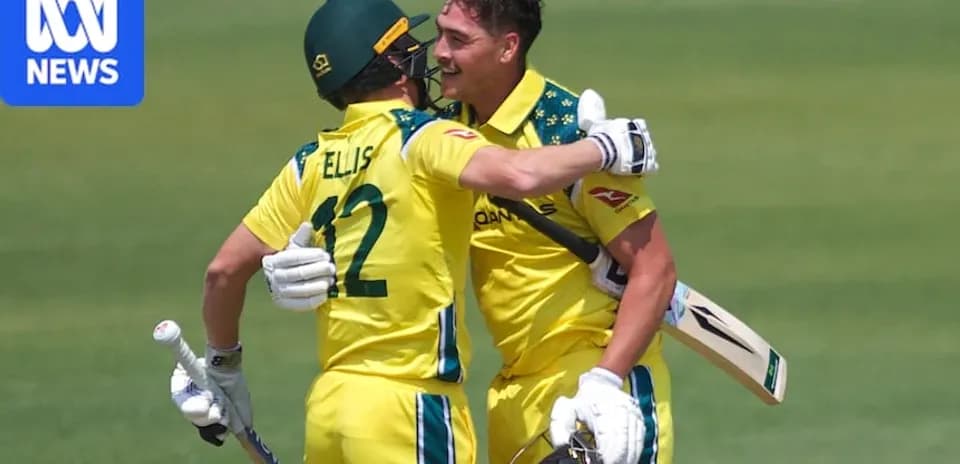 Two Australian cricketers celebrating on the field