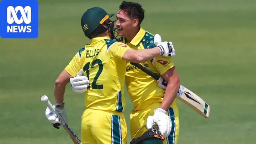 Two Australian cricketers celebrating on the field