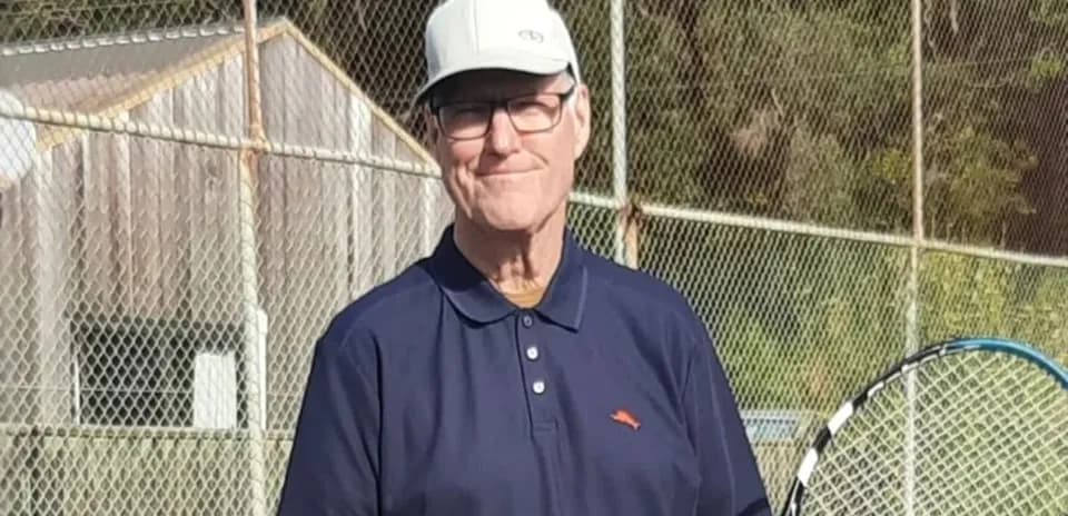 Man holding a tennis racket on a court