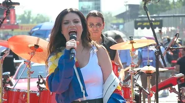 Singer performing on stage with band members
