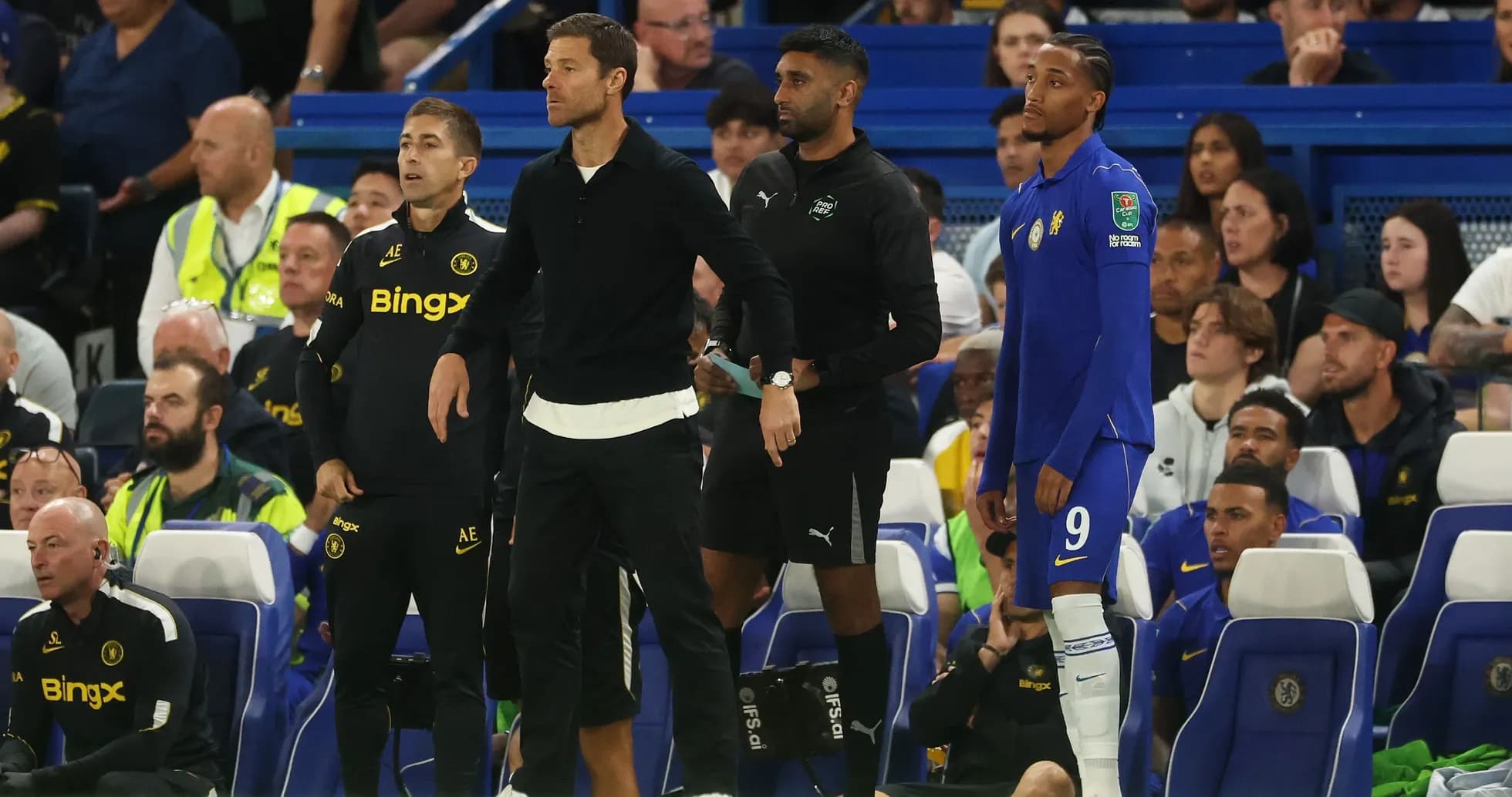 Coaching staff and player on the bench during match