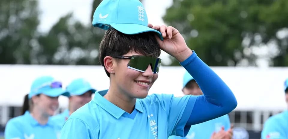 Player adjusting cap during team event outdoors