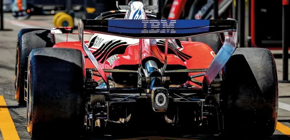 Red Formula 1 car in pit lane during race