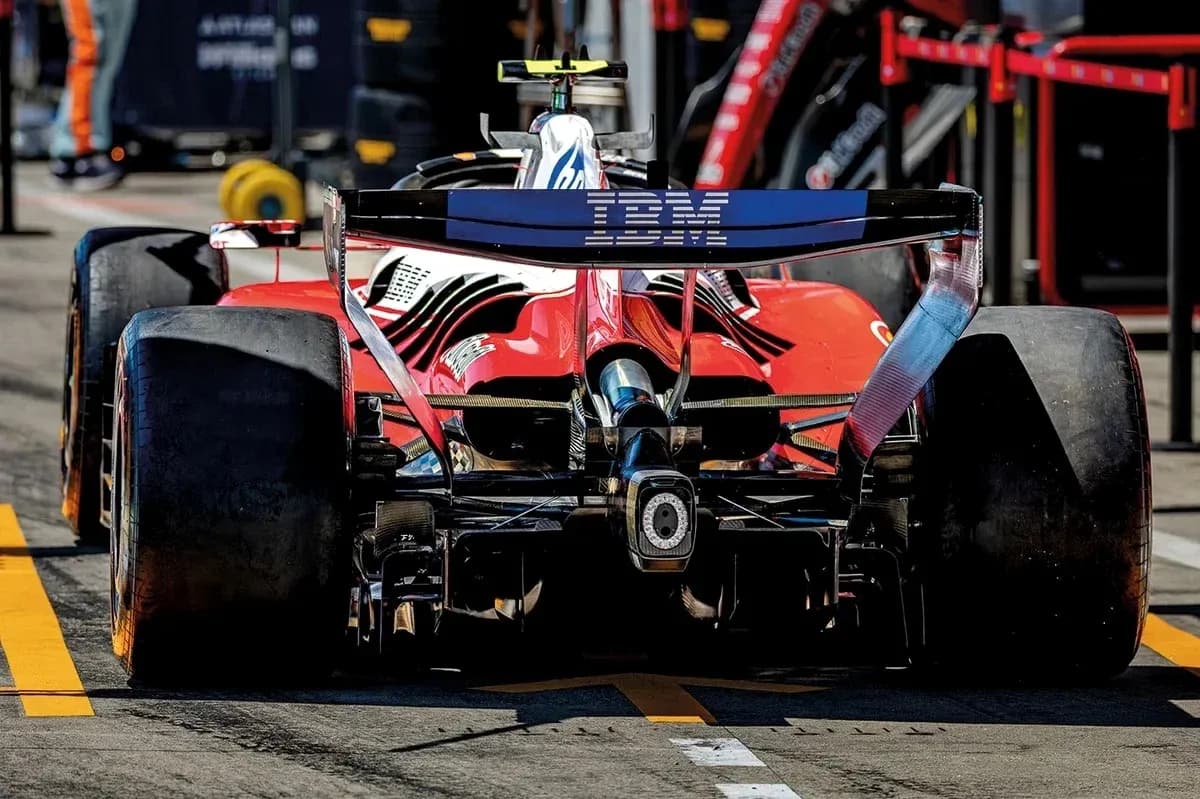 Red Formula 1 car in pit lane during race