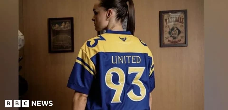 Person wearing a blue and yellow jersey with 'United 93'