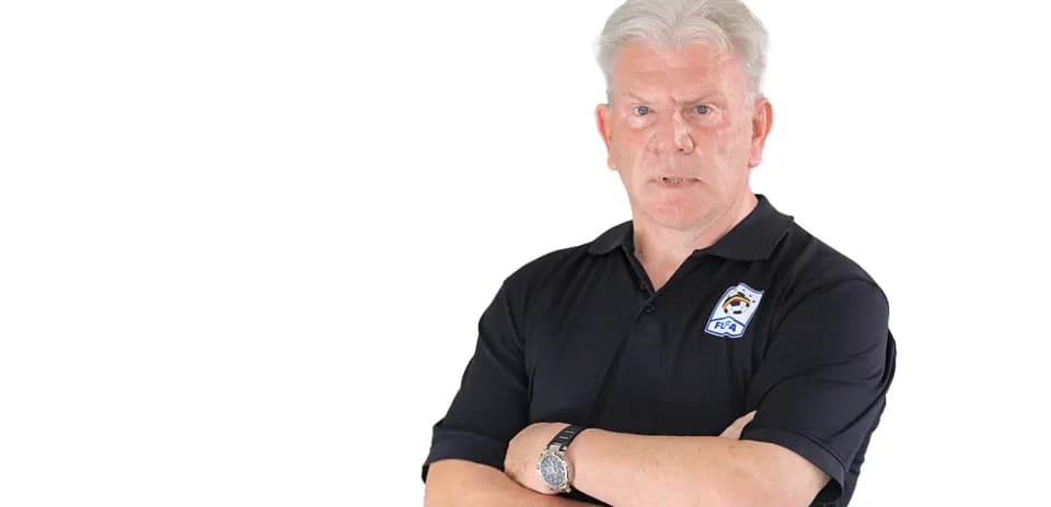 Man in black polo shirt with arms crossed