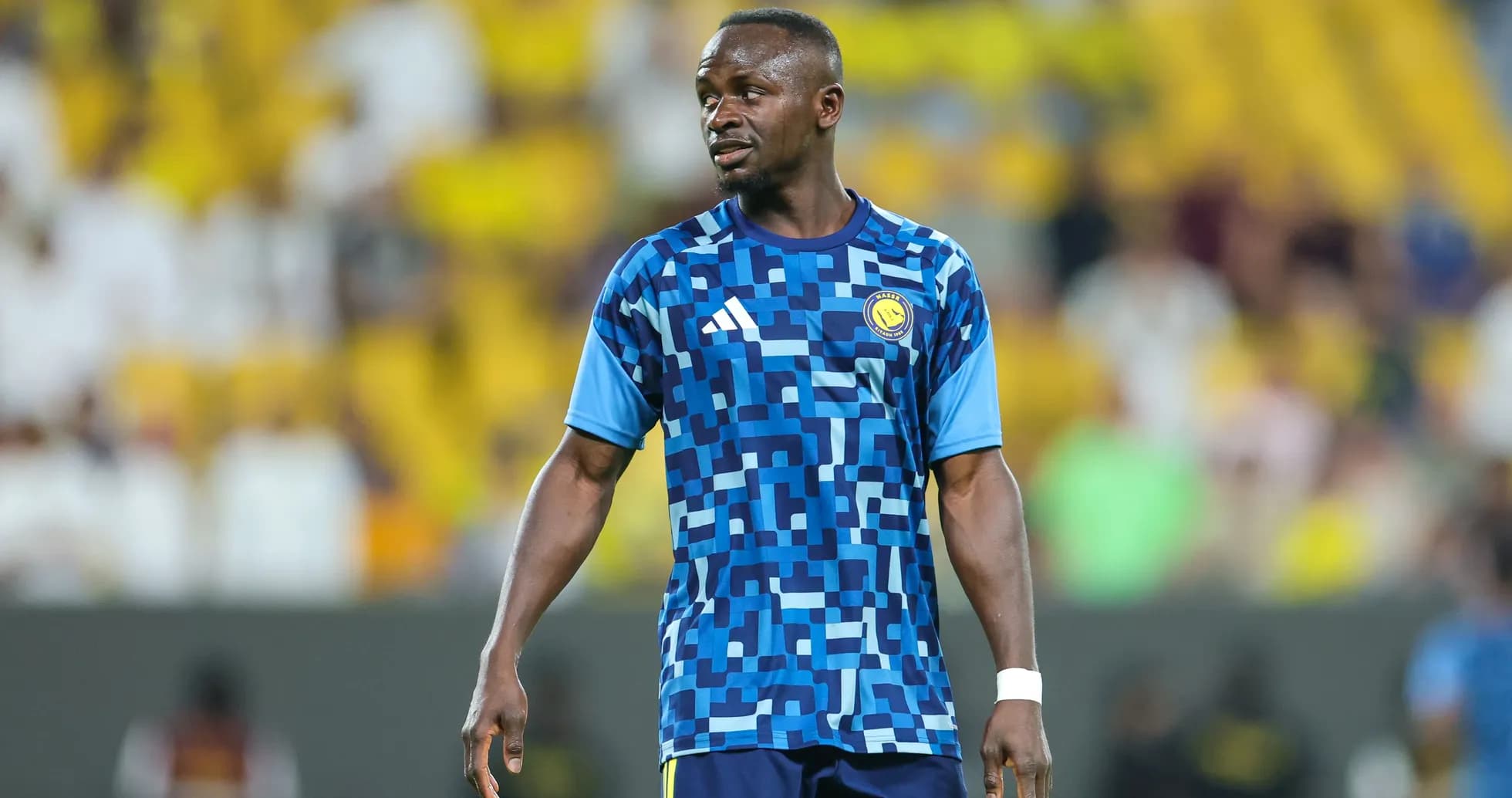 Player wearing blue training kit on the field