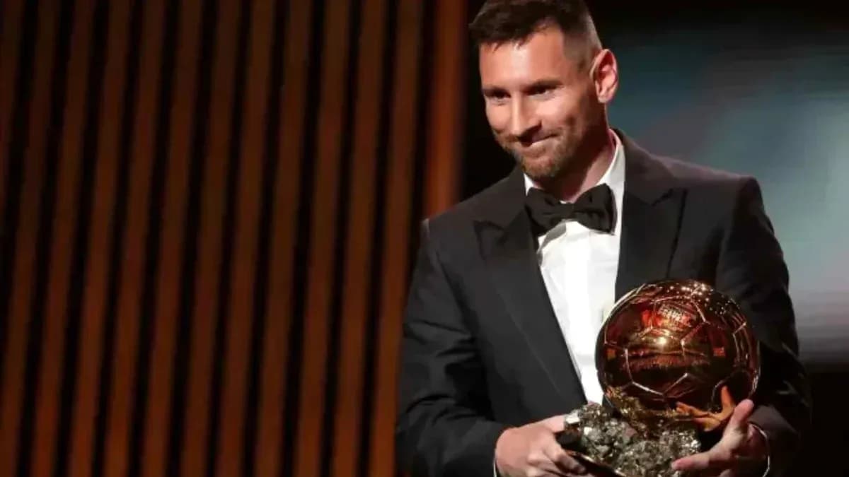 Player holding Ballon d'Or trophy on stage