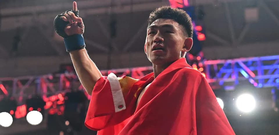 Boxer celebrating victory while holding a flag