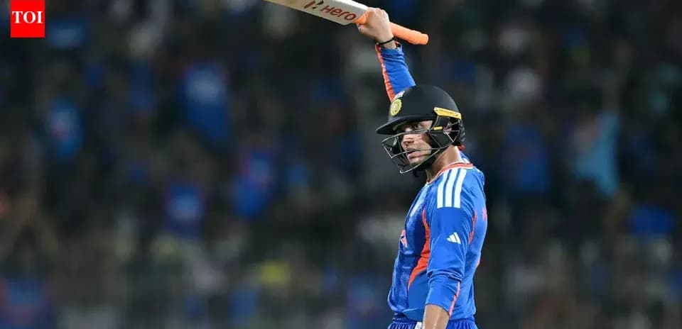 Cricketer celebrating with bat raised in air