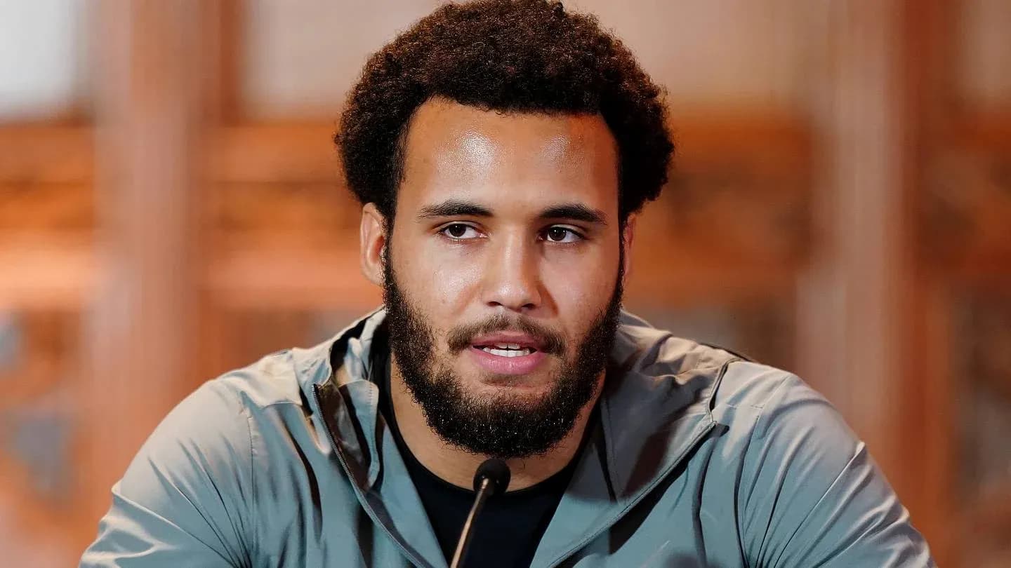 Athlete speaking at a press conference podium