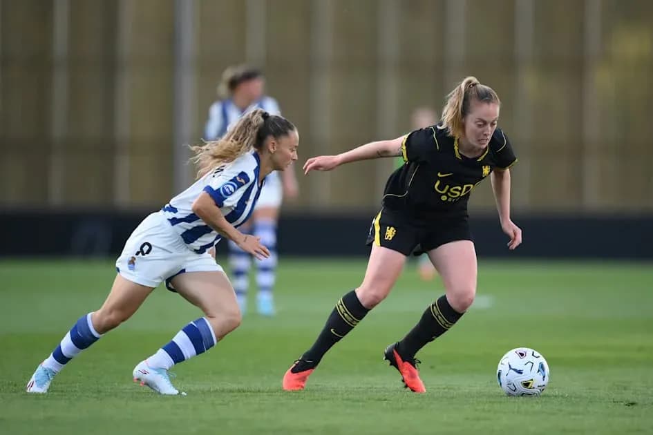 Two players competing for the ball on field