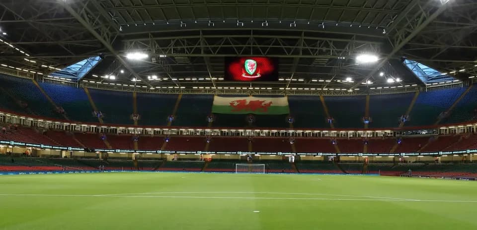 Empty stadium with Welsh flag displayed prominently
