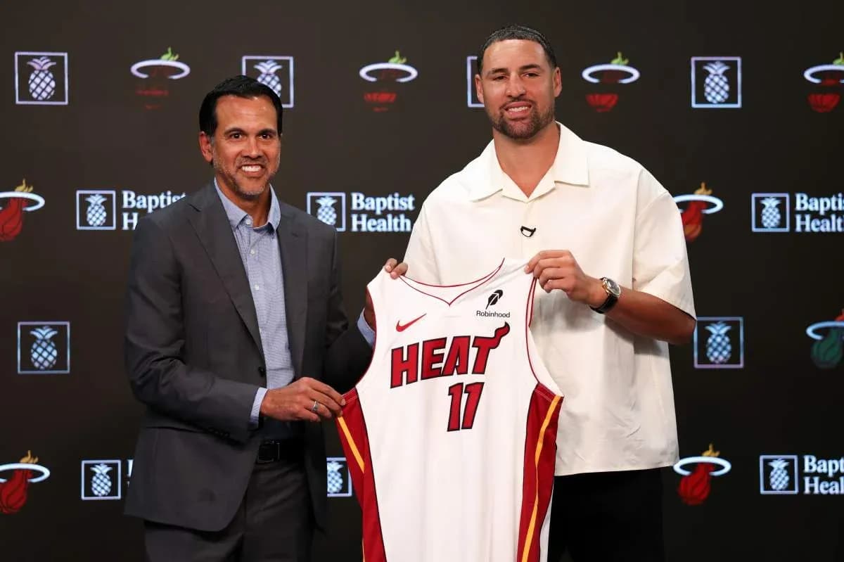 Coach and player presenting Miami Heat jersey