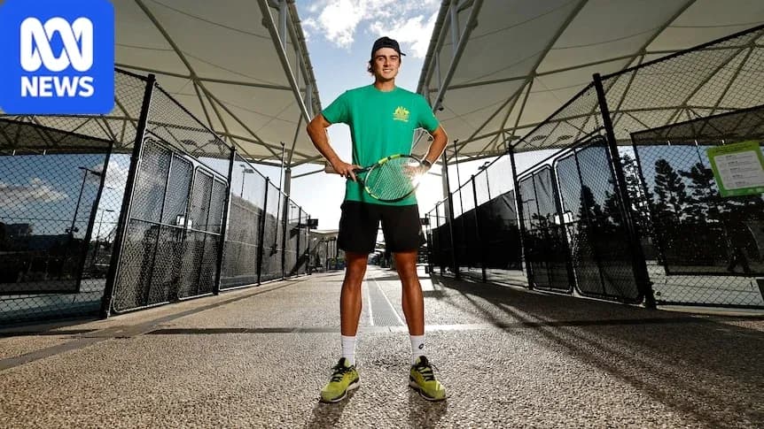 Tennis player posing with racket on court