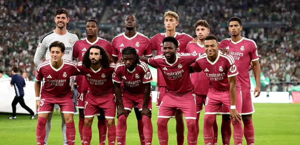 Real Madrid team posing before match in pink uniforms