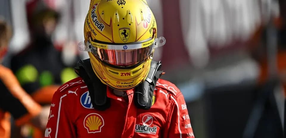 Racing driver in Ferrari suit and helmet