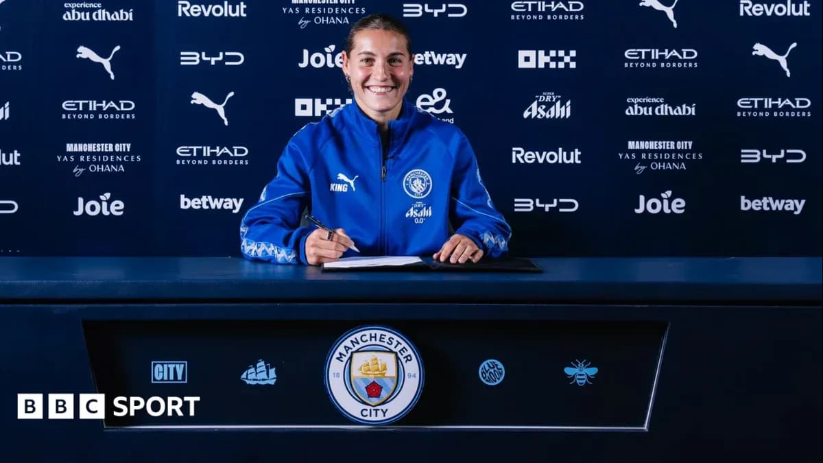 Player signing contract at Manchester City press table