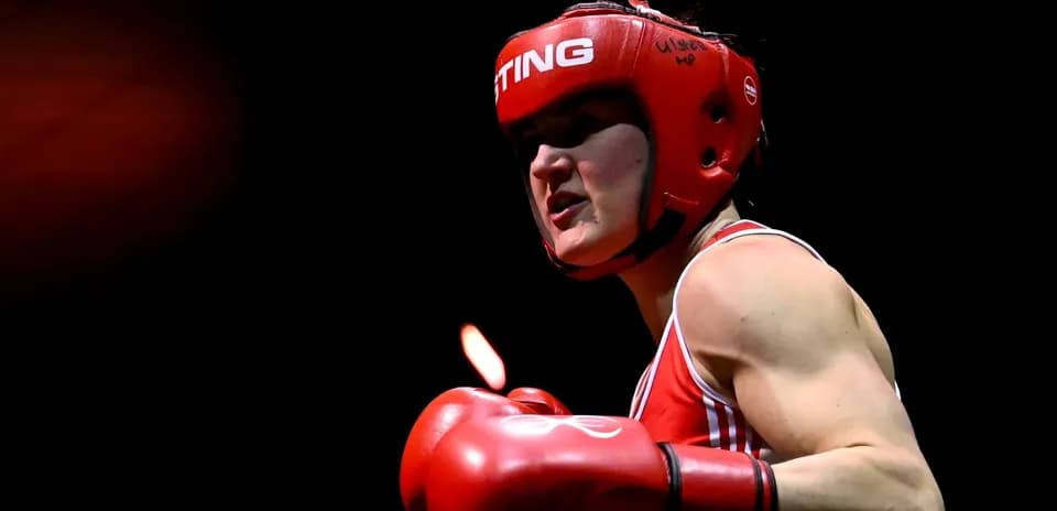 Female boxer in red gear preparing to strike