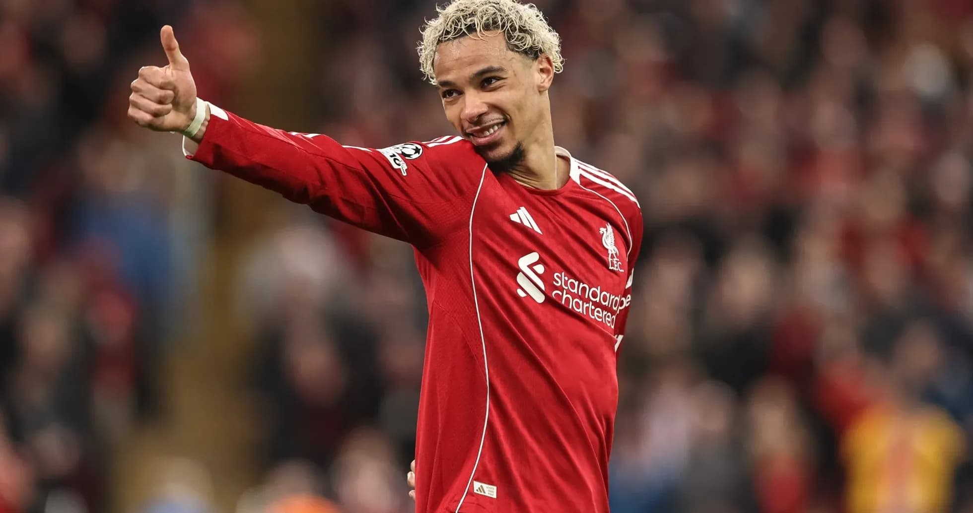 Player celebrating with thumbs up in Liverpool kit