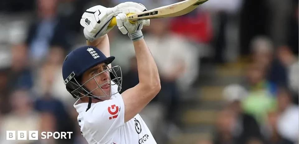 Cricketer batting with raised bat during match