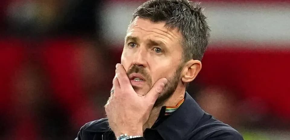 Coach contemplating strategy during match on sidelines