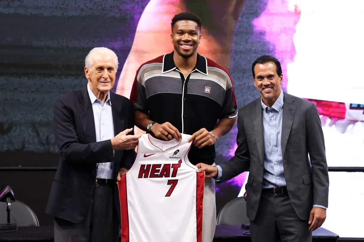 Player holding Miami Heat jersey at press event