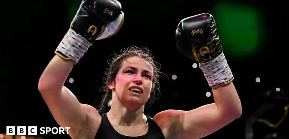 Female boxer celebrating victory with raised fists