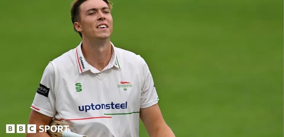 Cricketer walking off field after innings