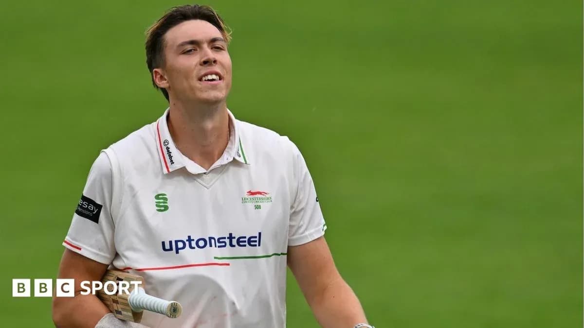 Cricketer walking off field after innings