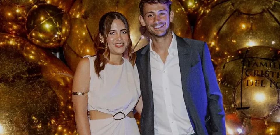 Couple posing together at a festive event