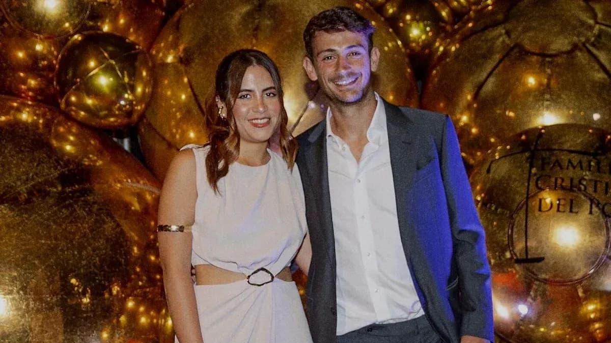 Couple posing together at a festive event