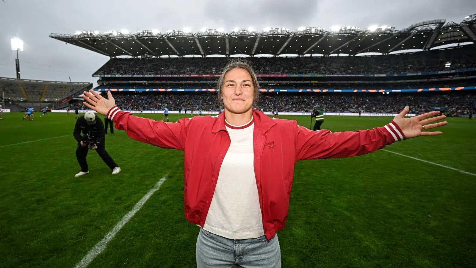 Person celebrating on the pitch at a stadium